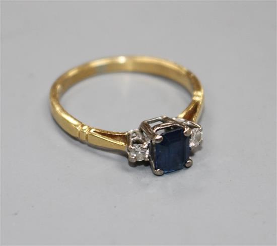 An 18ct, sapphire and diamond three stone ring, size N, gross weight 2.6 grams.